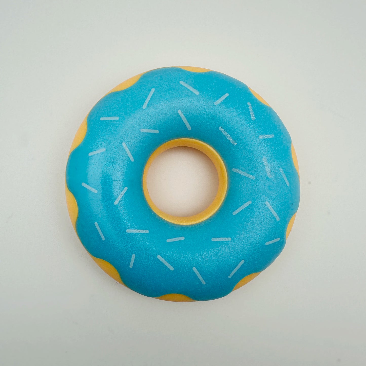Rubber donut dog toy with functions of grinding teeth, cleaning teeth, interactive companionship, relaxation, and vocalization